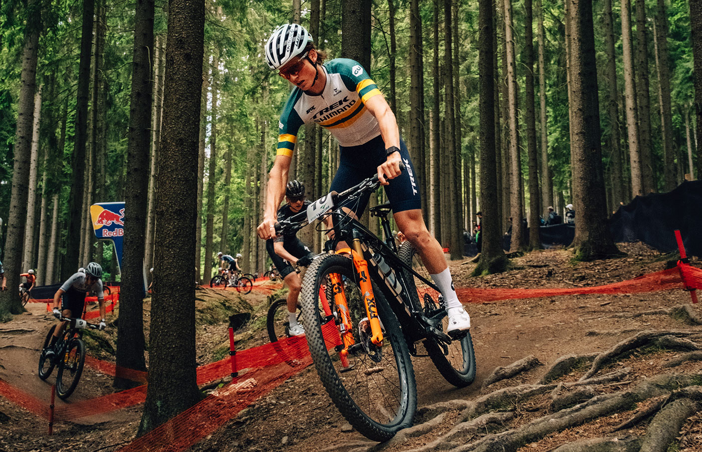 MTB rider Connor Wright riding through a forest during a competition.