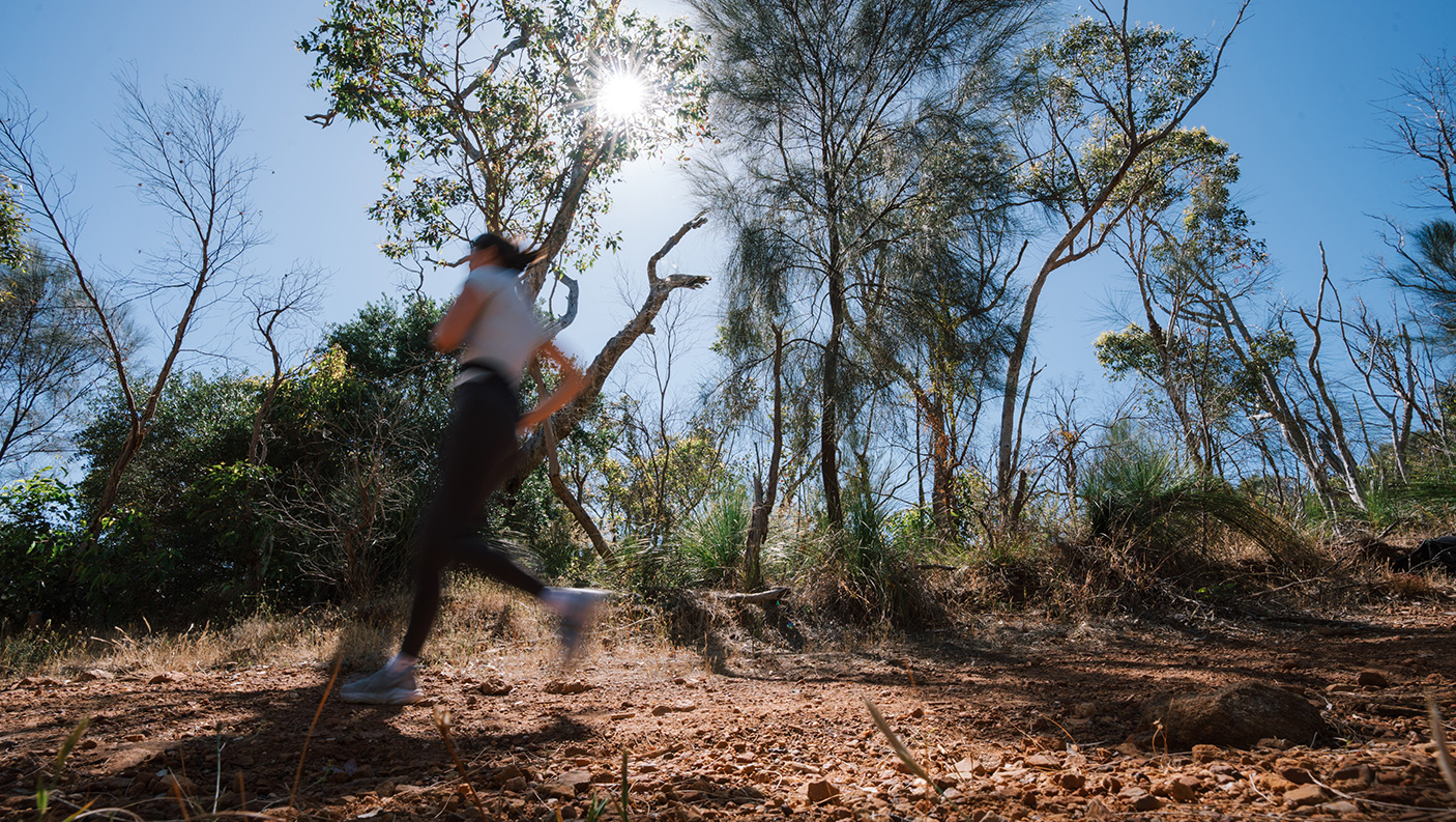 A trail runner on a bush walking track