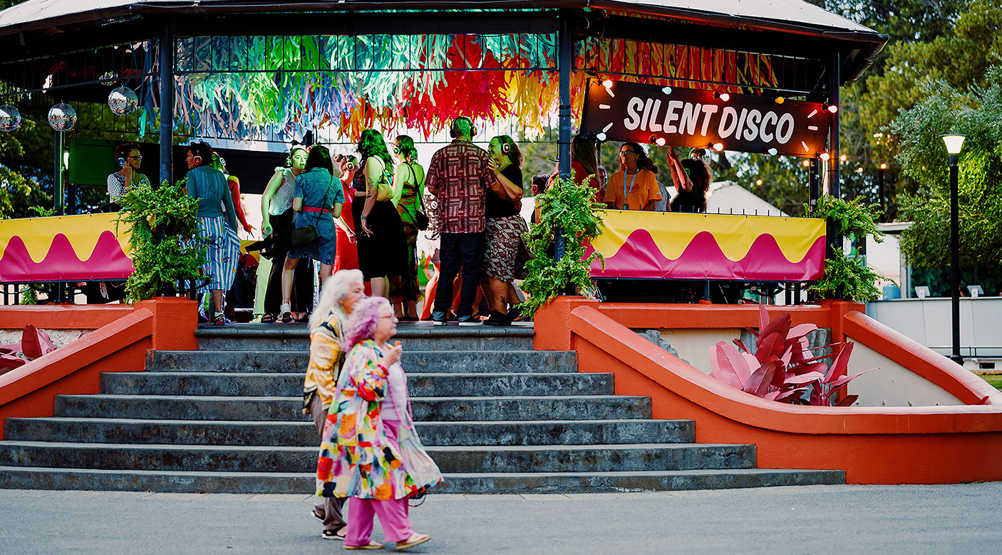 A silent disco is taking place in a rotunda in a park