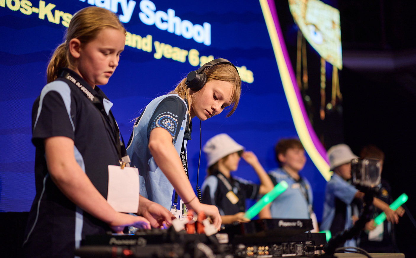 6 students on stage doing a DJ set at the Creative Learning Showcase
