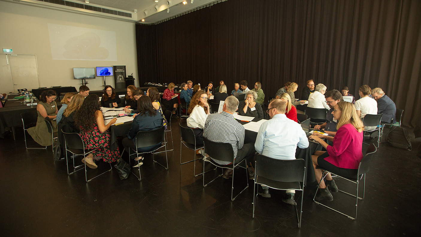 Delegates sit at tables at the Creative Industries Taskforce meeting in March 2026