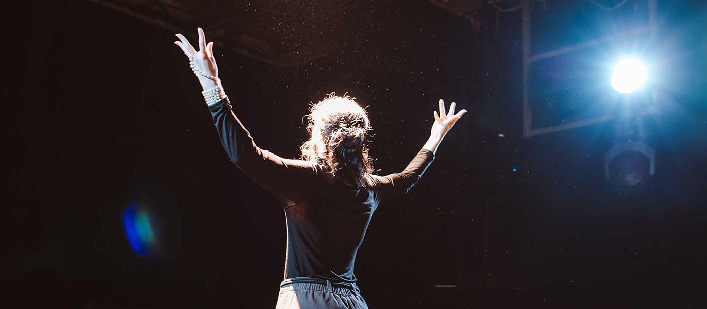 Stage performers practicing act together on stage in class