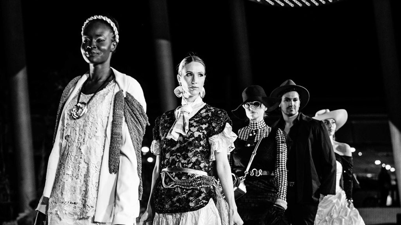 5 models on a runway during a fashion parade