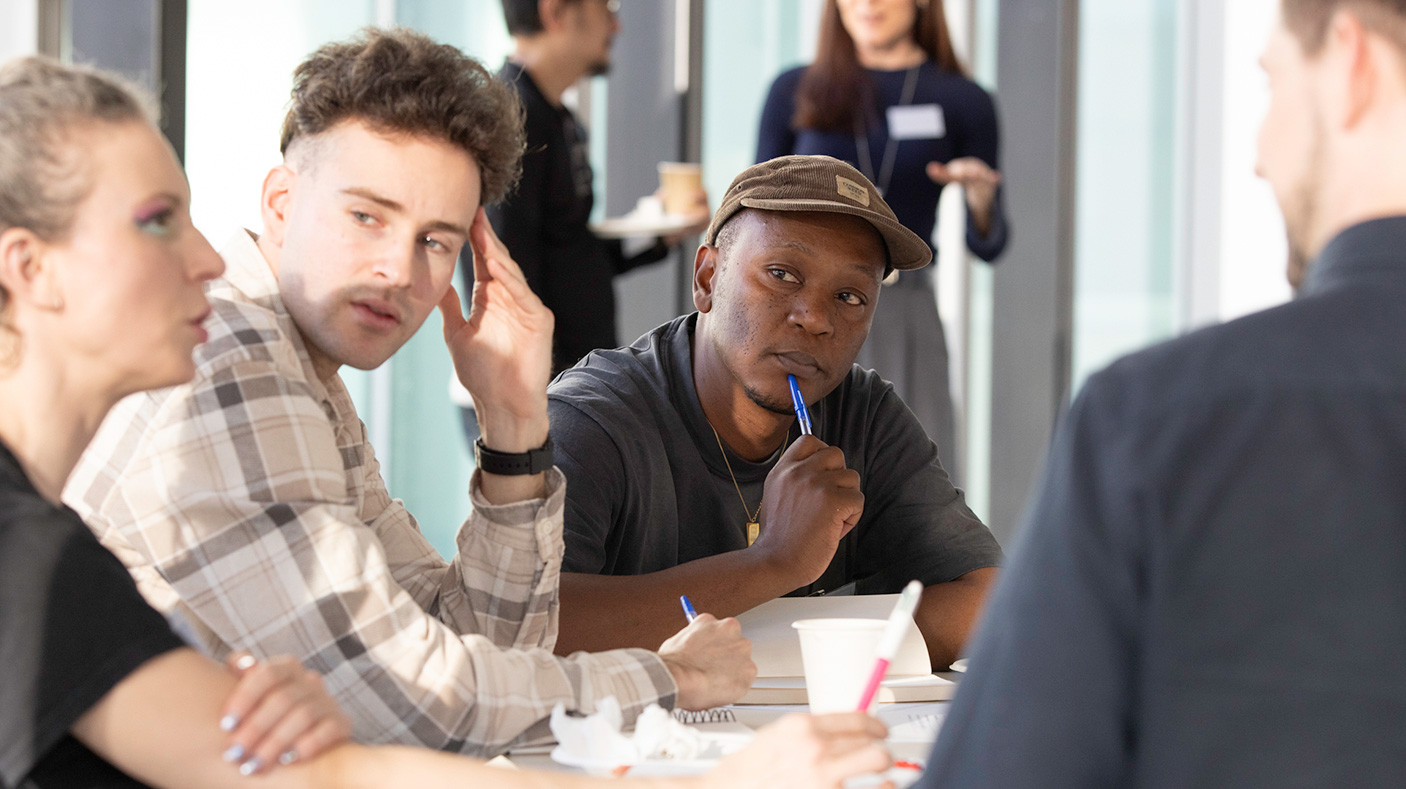 People at a table, in a workshop