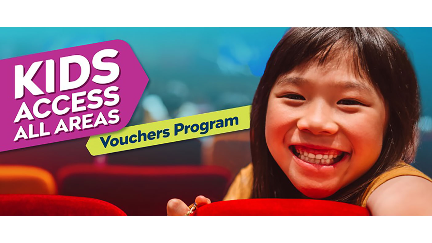 A young girl in a theatre smiling. Text reads Kids Access All Areas Vouchers Program