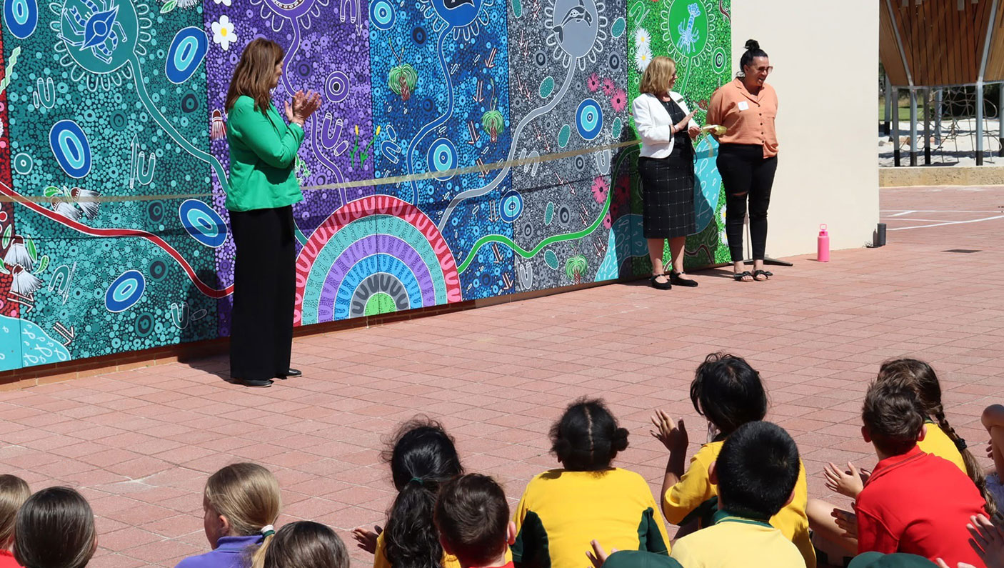 Frederick Irwin Anglican School:students and adults enjoying the colourful murals