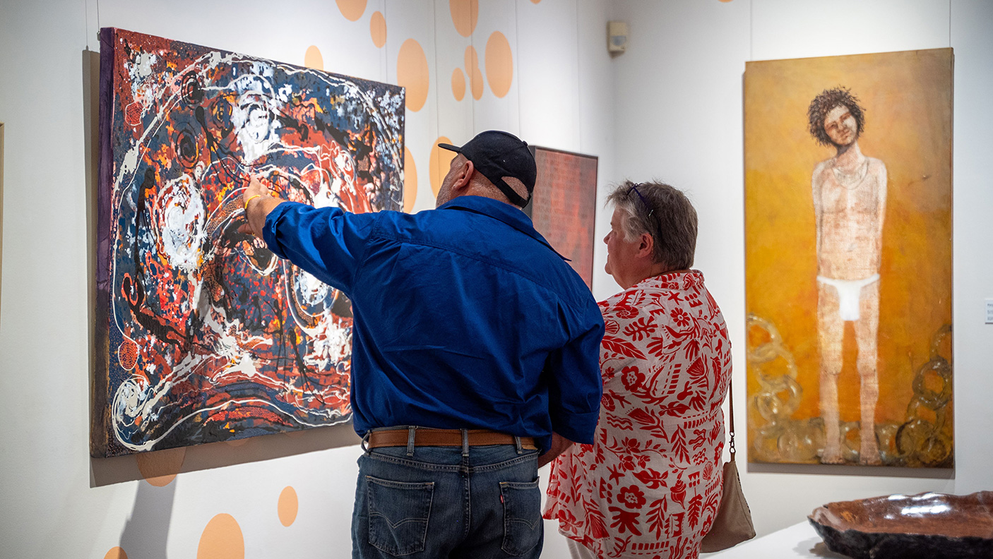 A man and a woman looking at artworks in the Bunbury Regional Gallery
