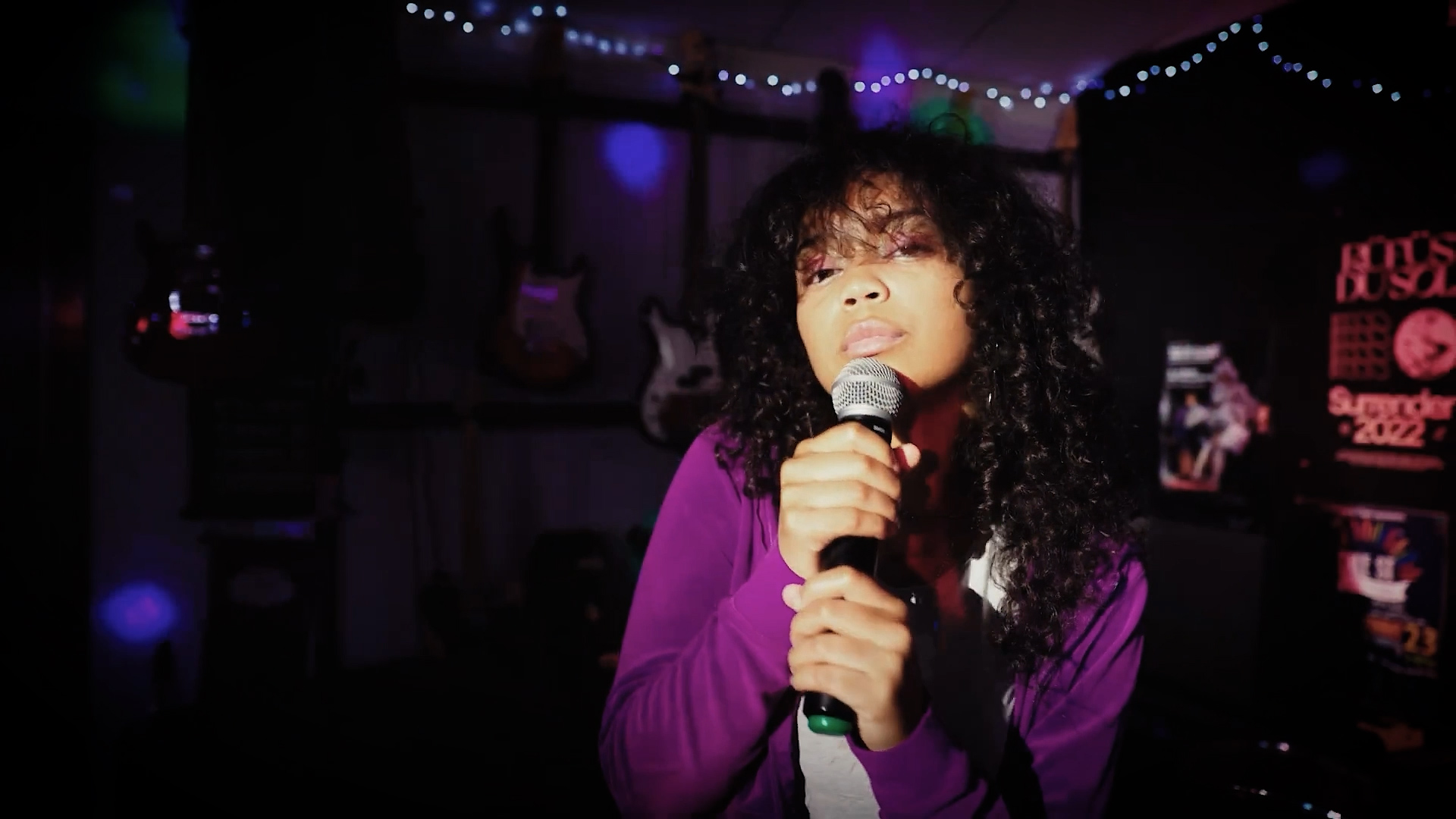 A young singer in a recording studio