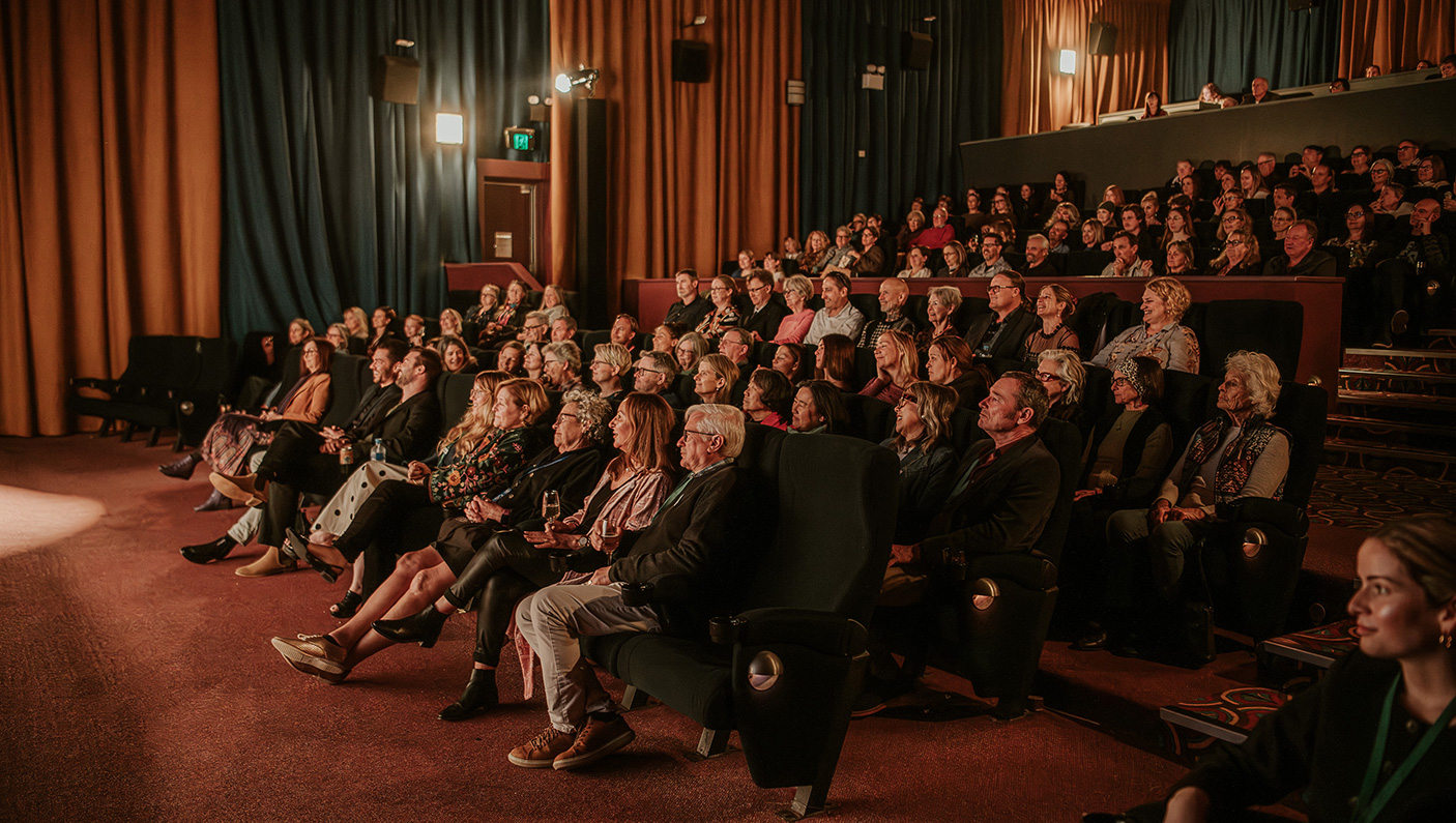 An audience in a movie theatre watching a movie