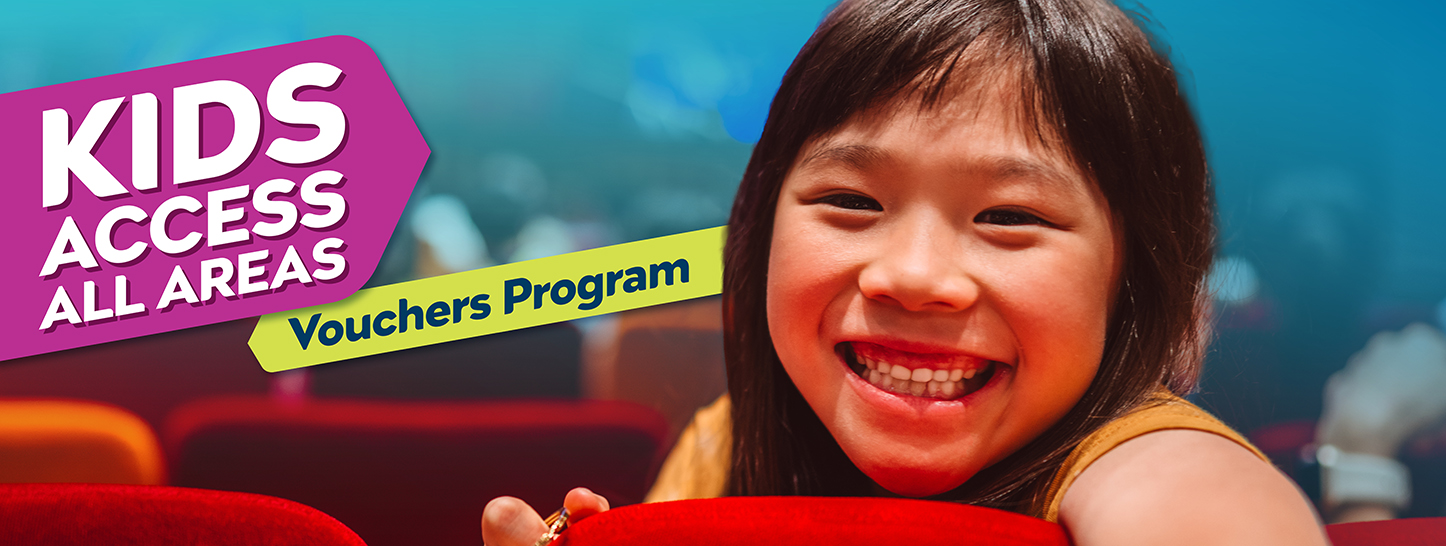 A girl in a theatre smiling with the words, 'Kids Access All Areas Vouchers Program'