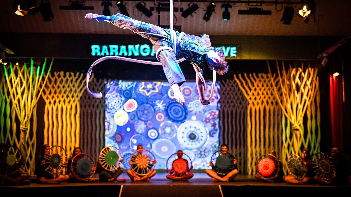 A performance artist in costume, suspended of a rope