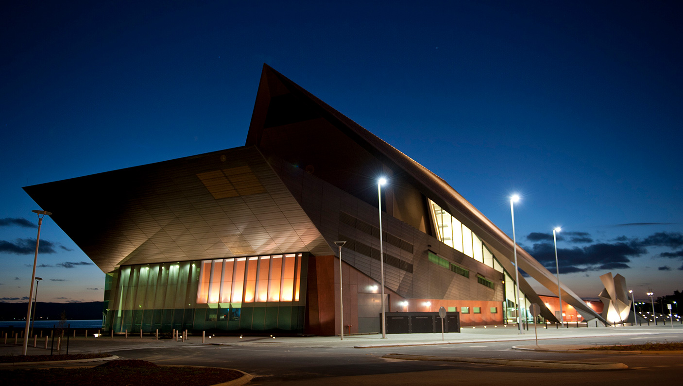 The outside of the Albany Entertainment Centre at dusk, with a dark sky and clouds in the backgroun