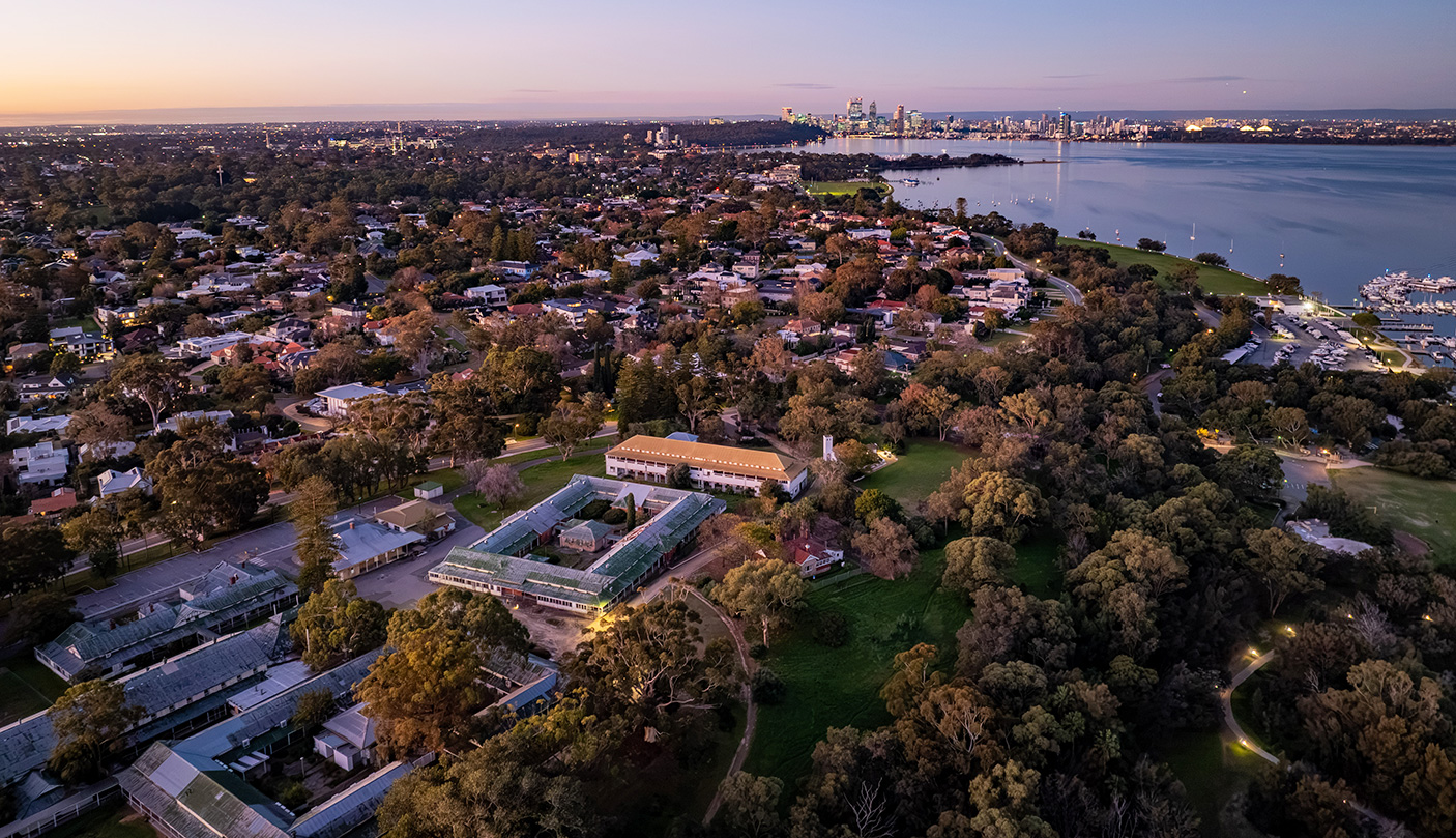 An aerial view of the unset Heritage Precinct and Swan River at Dusk, with the CBD in the far distance