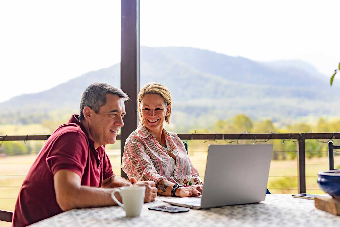 A man and a women conversing over a coffee.