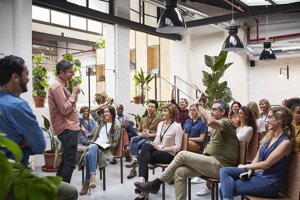 A man speaking to a group of seated people