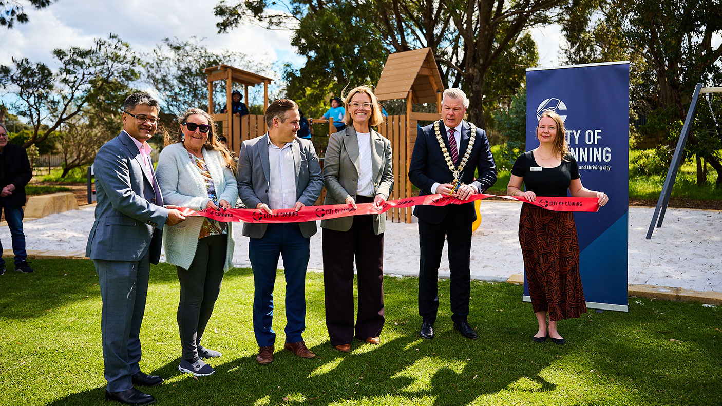 Officials cutting the ribbon at the opening of the new Wisteria Park