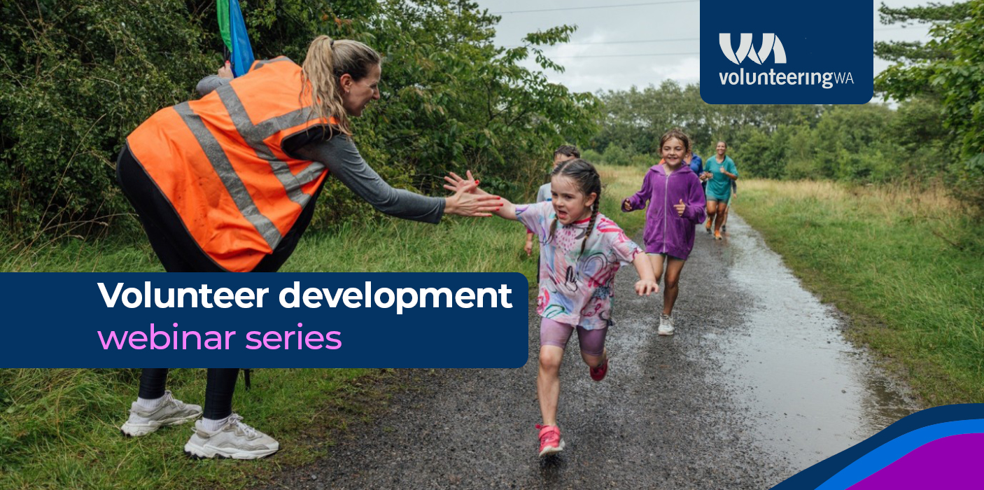 A volunteer high fives children in a running race