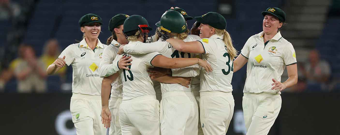 7 sports women, wearing identical sports t shirts, huddle together