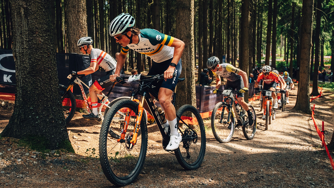 Connor Wright leads a race during a ride through a forest.
