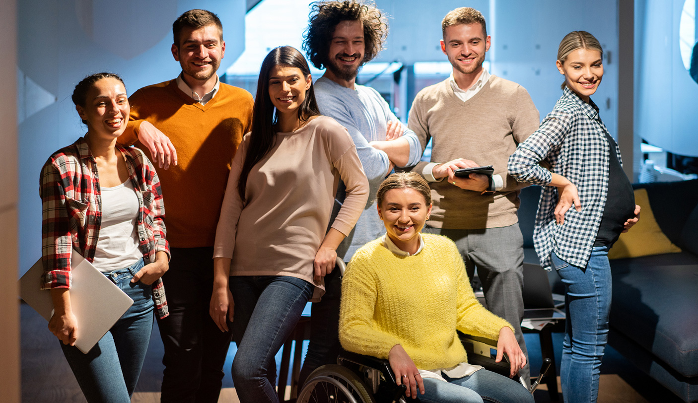 A diverse group of people stand together