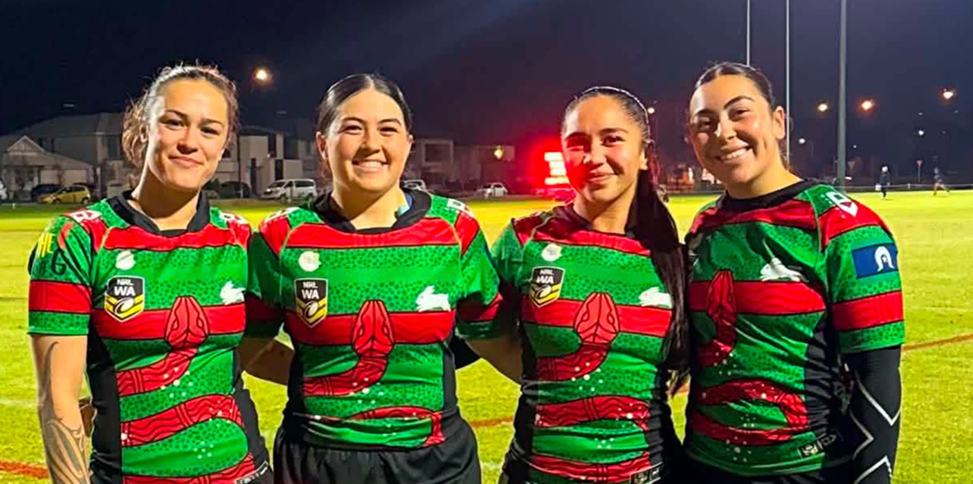 A group of Ellenbrook Rabbitohs female players smiling to the camera.