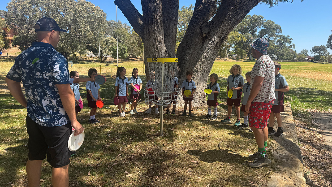 Students and a teacher in a school yard