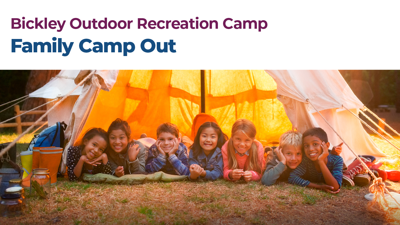 A group 7 young people lying in a tent looking out the tent door, at night