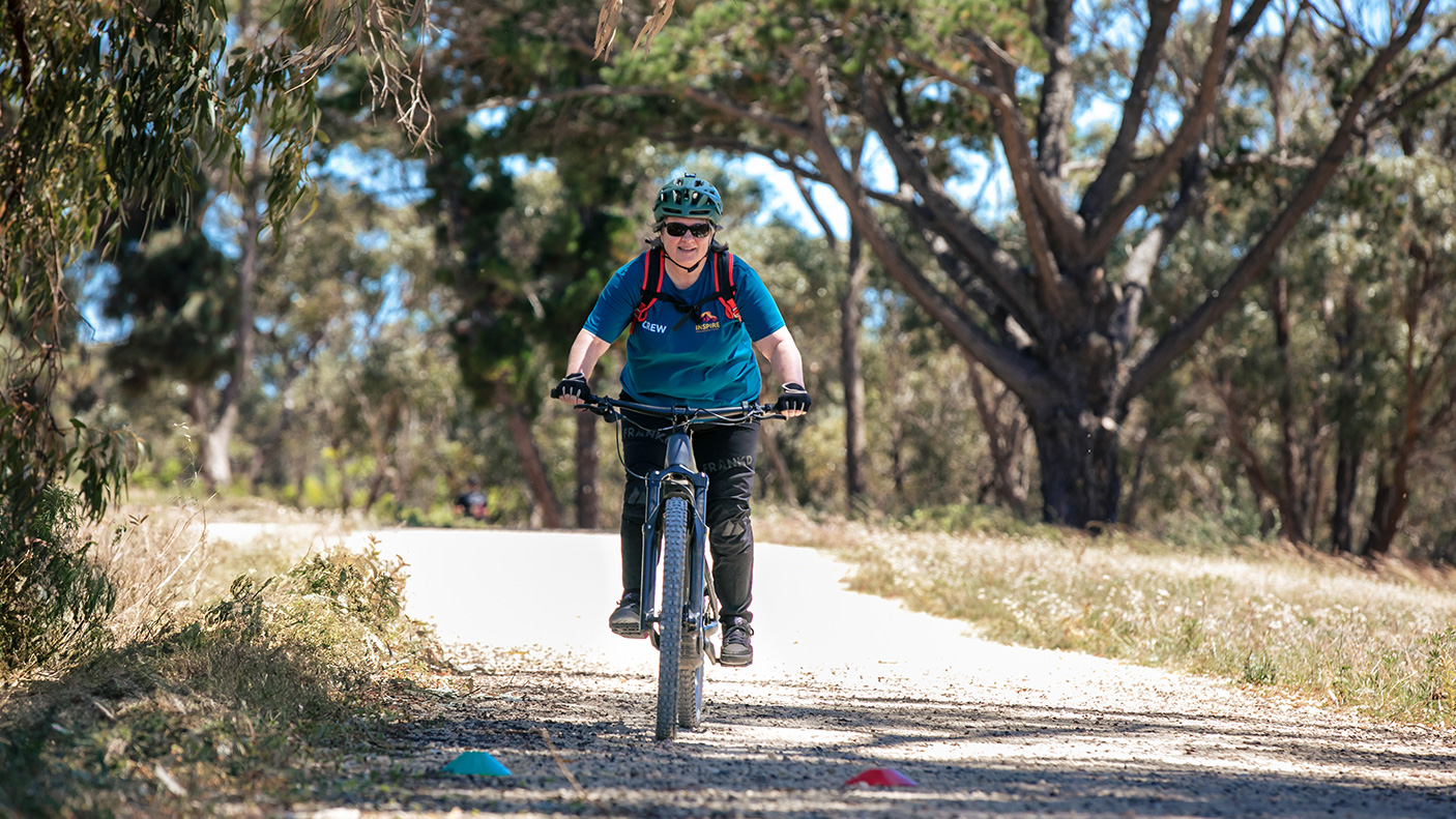 A female mountain bike rider on a bush track