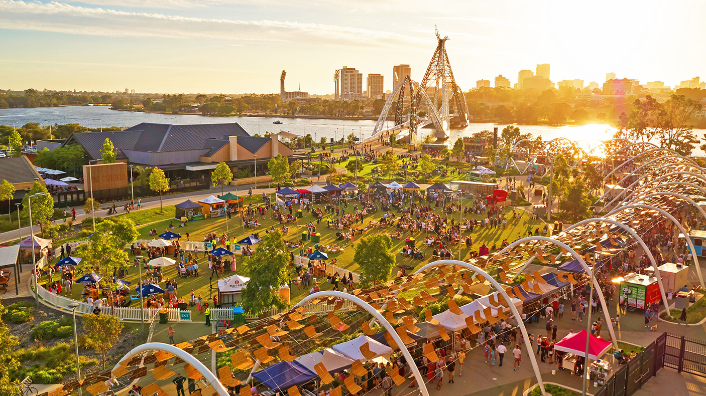 An aerial view of the Little Italy festival at sunset, with Perth city skyline in the background