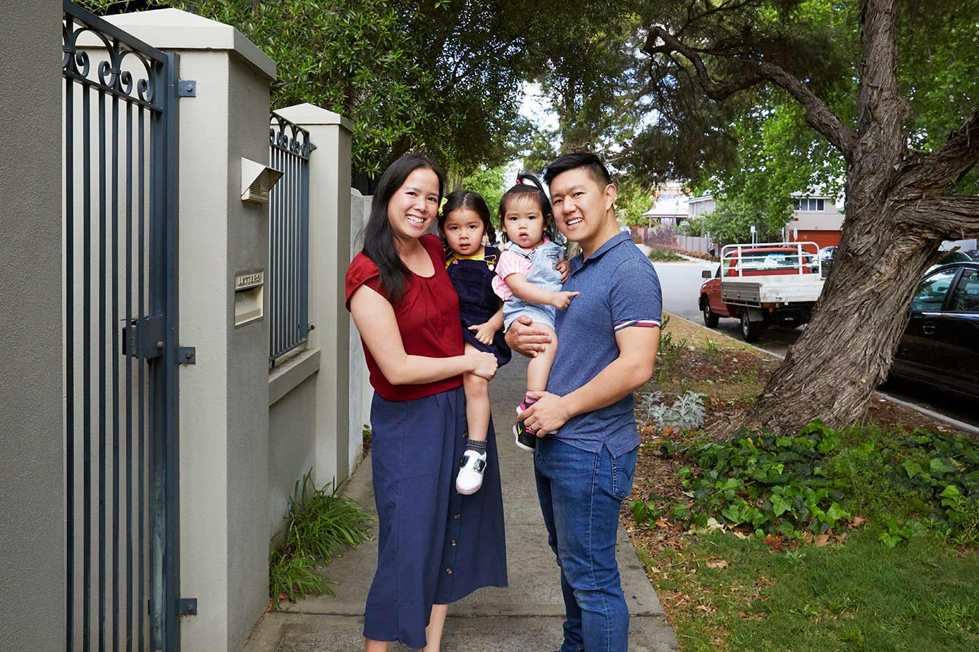 A young family standing on a footbpath