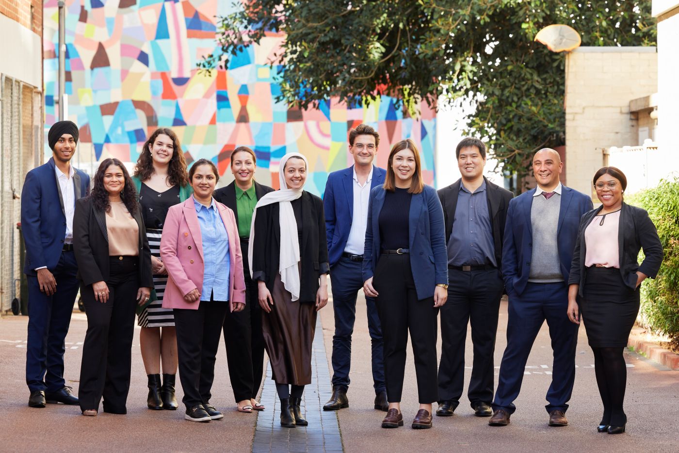 A group of people standing and smiling at the camera